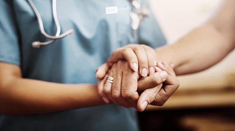Patient and Nurse Embracing Hands
